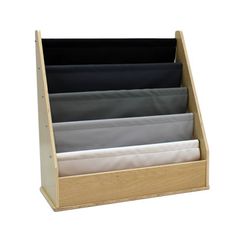 a wooden desk organizer with six folded papers