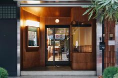 an entrance to a building with wooden panels and glass doors that lead into the lobby