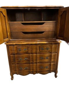 an old wooden dresser with its doors open