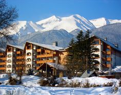 a hotel in the mountains covered with snow