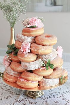 a large stack of doughnuts sitting on top of a table