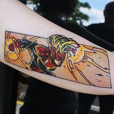 a person with a tattoo on their arm that has an image of a woman holding a surfboard