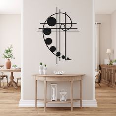 a room with a table and wall decal in the shape of an abstract design