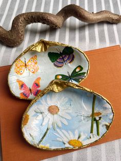 two decorative dishes are sitting on a table