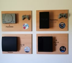 four wooden plaques with video game controllers mounted on the wall next to eachother