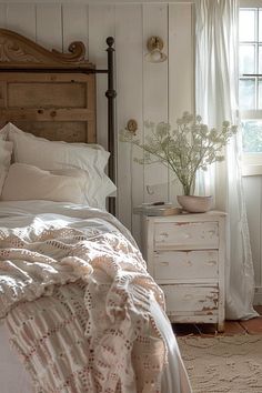 a bedroom with a bed, dresser and window