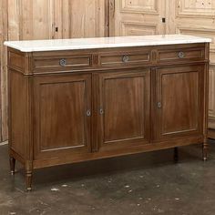 a large wooden cabinet with marble top