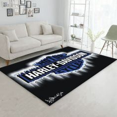 an area rug with the words harley davidson on it in front of a white couch