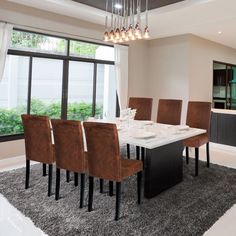 the dining room table is set with six brown chairs, and there are no people around it