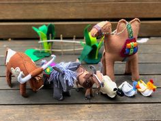 several small stuffed animals on a wooden table