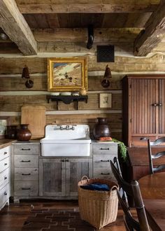 an old fashioned kitchen with wooden walls and flooring