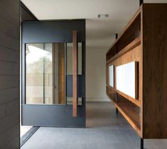 an open door leading into a room with wood paneling on the walls and floor