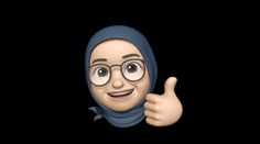 a person wearing glasses and a headscarf giving the thumbs up