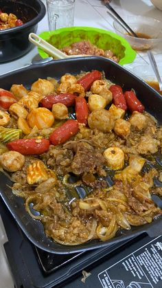 a pan full of food sitting on top of a stove