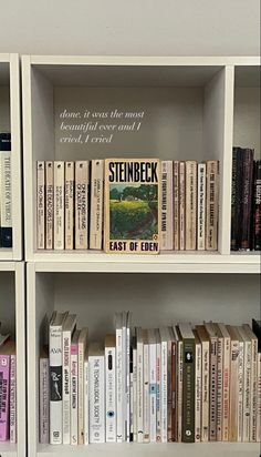 two white bookshelves filled with different types of books on top of each other