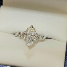 an engagement ring with a pear shaped diamond