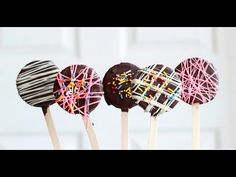 three chocolate covered lollipops with sprinkles on them