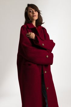 The Cathrine Wool Coat is a relaxed fit, single-breasted carcoat. This woolen, heavy weight style has a soft texture and finish with piping on the inside. It features welt pockets and visible stitching detailing, with button closure and cuff straps. This sustainable coat is tailor made and on demand. It takes us 10 hours to make this coat. PLEASE ALLOW 1-3 BUSINESS DAYS FOR PRODUCTION Red Oversized Wool Outerwear, Red Wool Oversized Outerwear, Oversized Red Wool Outerwear, Red Notch Lapel Outerwear With Pockets, Red Oversized Outerwear With Buttons, Oversized Red Outerwear With Buttons, Red Winter Outerwear With Button Cuffs, Red Wool Outerwear With Button Closure, Classic Oversized Single Breasted Sweater Coat