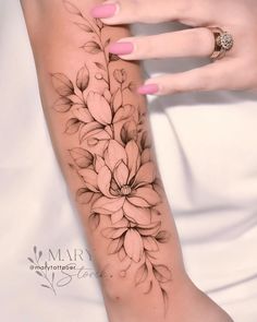 a woman's arm with flowers on it