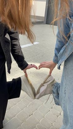 two girls are holding onto each other's shoes