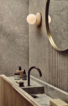 a bathroom sink sitting under a mirror next to a faucet