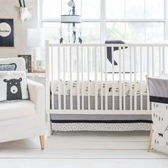 a baby's room with a crib, chair and pictures on the wall