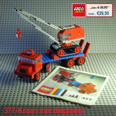 an orange and blue lego truck with a crane on it's back, next to a poster