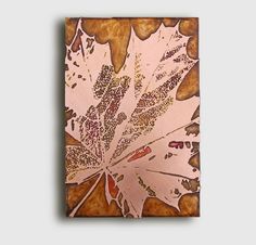 a painting of a maple leaf on a brown background