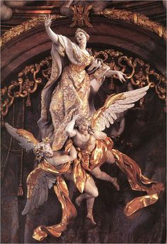 the statue is surrounded by gold and white wings on it's back end, as well as an angel with outstretched arms