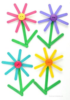 four popsicle flowers are arranged in the shape of sunflowers