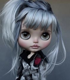 a close up of a doll with grey hair