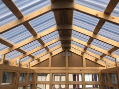 the inside of a building with wooden beams and windows