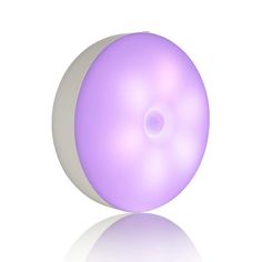 a white and purple object is shown on a white surface, with the light reflecting off it's side