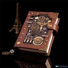 a brown book with gears on it sitting in front of a eiffel tower