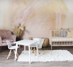 a baby's room with a white table and chairs