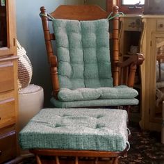 a rocking chair and footstool in a living room