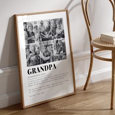 an old photo frame sitting on the floor next to a table with a book and chair