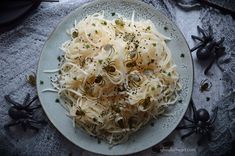 a white plate topped with spaghetti and spider webs