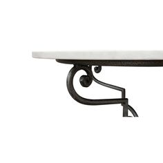 a white marble topped table with wrought iron brackets on the top and bottom, against a white background