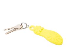 a yellow plastic keychain with a flower on it