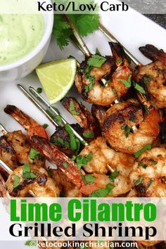 grilled shrimp on skewers with cilantro and lime garnish