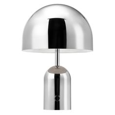 a lamp that is on top of a white surface with a black and silver base