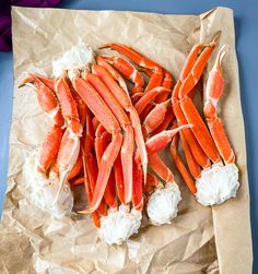 some crab legs are laying on top of each other and ready to be cooked in the oven