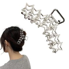 a woman wearing a hair clip with stars attached to the back of her head, in front of a white background