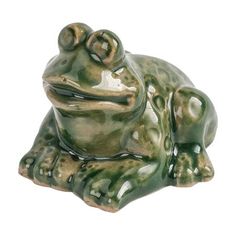 a green frog statue sitting on top of a white surface