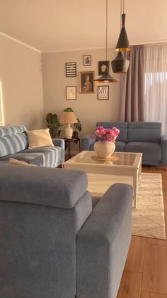 a living room with blue couches and white coffee table