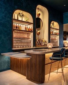 an elegant bar with blue walls and gold trim