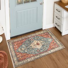 a blue front door with a rug on the floor