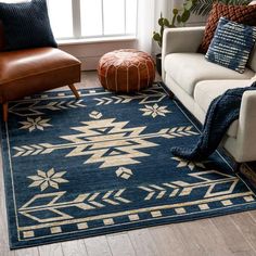 a living room with a couch, chair and rug on the floor in front of a window