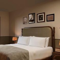 a hotel room with a bed and pictures on the wall